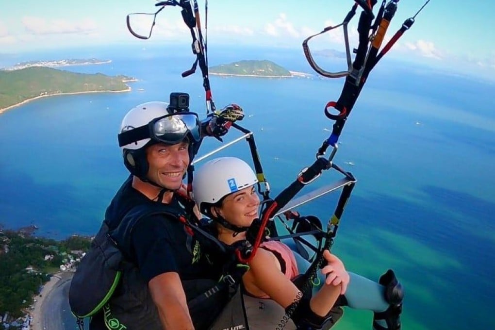 Emil Kaminski (left), the chief pilot at Hong Kong Hike ‘N’ Fly, a tandem paragliding operator, poses for a photo as he takes a person paragliding. Photo: Emil Kaminski