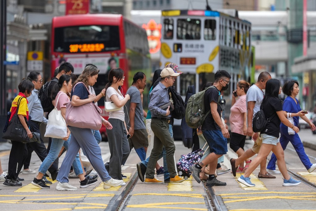 Hongkongers cross a street in Central district on October 10. The city must tap its core strengths – its openness, respect for rule of law, and vibrant multicultural environment – to attract a diverse pool of top talent. Photo: Eugene Lee