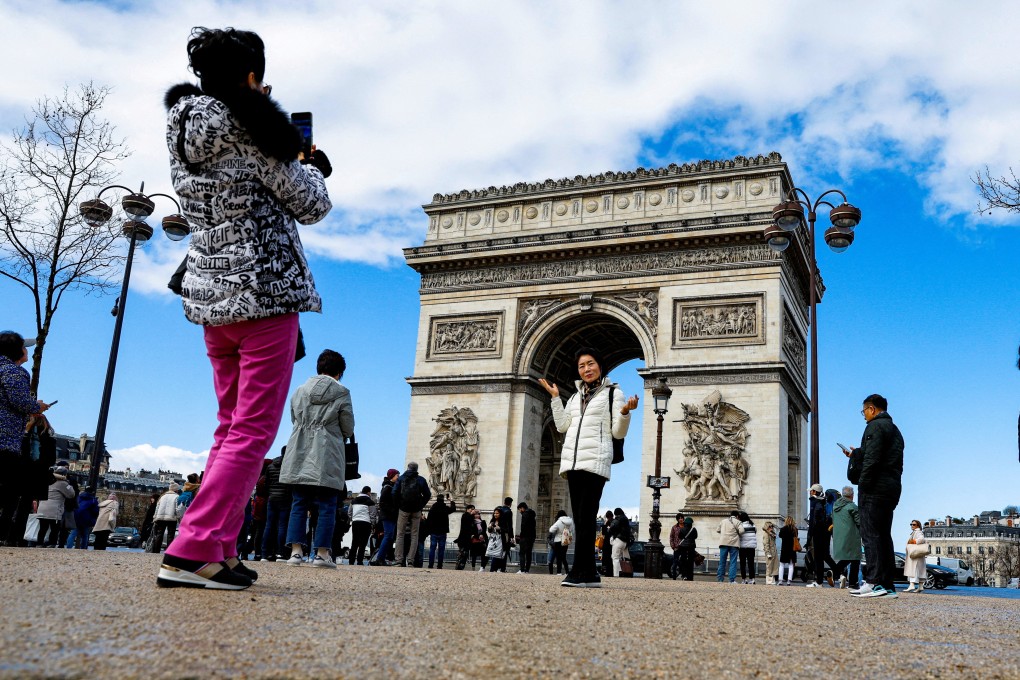 A Chinese tourist poses for a photograph in Paris in March last year. Photo: Reuters