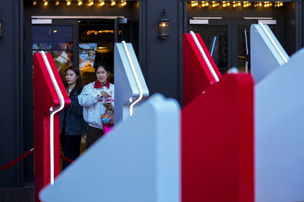 Women walk out from a fashion boutique at a shopping mall in Beijing. Photo: AP