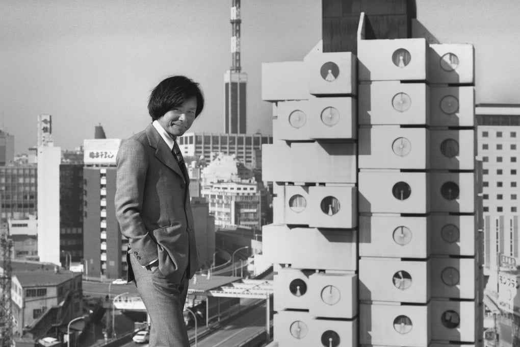 Architect Kisho Kurokawa with his creation, Japan’s Nakagin Capsule Tower, in 1972. Photo: Tomio Ohashi/M+