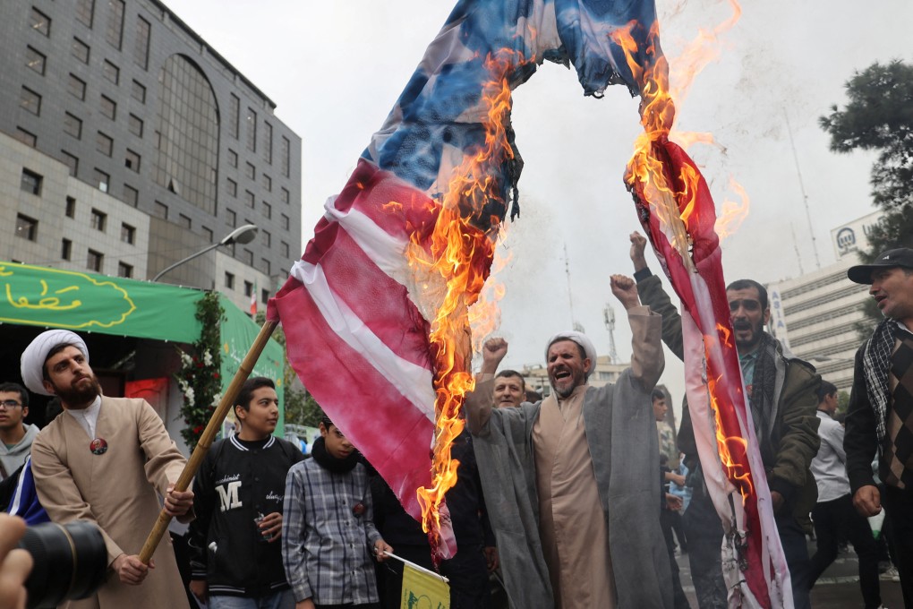 Iranians burn a US flag to mark the 45th anniversary of America’s expulsion from Iran on Sunday. Photo: West Asia News Agency via Reuters