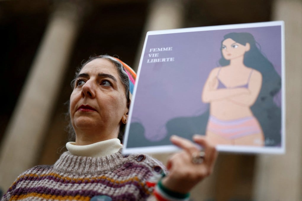 A woman in Paris, France on Tuesday holds a placard in support of an Iranian female student seen in her underwear at a Tehran university. The slogan reads “Woman, Life, Freedom”. Photo: Reuters