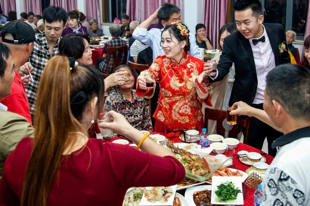 A bridegroom and bride toast with friends and relatives at a wedding banquet in Shanghai. Chefs in Hong Kong break down Chinese wedding banquets must-haves. Photo: Shutterstock