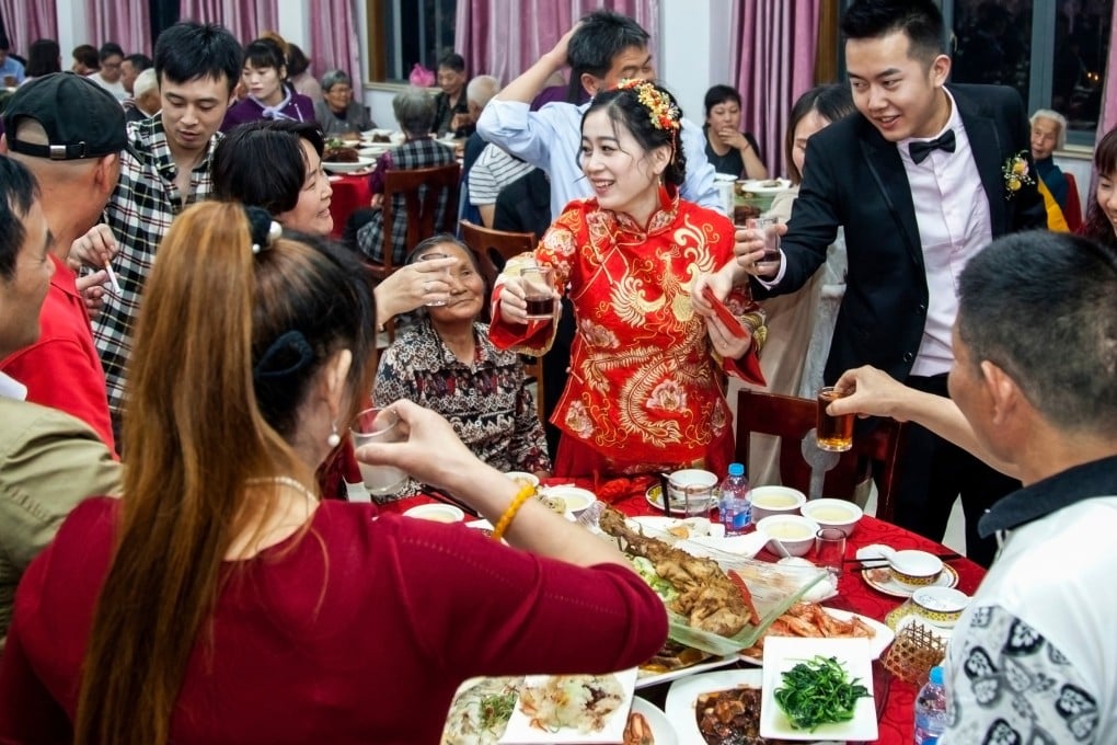 A bridegroom and bride toast with friends and relatives at a wedding banquet in Shanghai. Chefs in Hong Kong break down Chinese wedding banquets must-haves. Photo: Shutterstock
