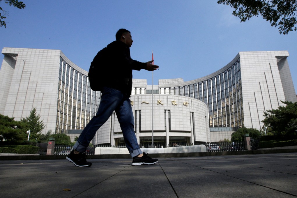 A man walks past the headquarters of the People’s Bank of China in Beijing. Photo: Reuters