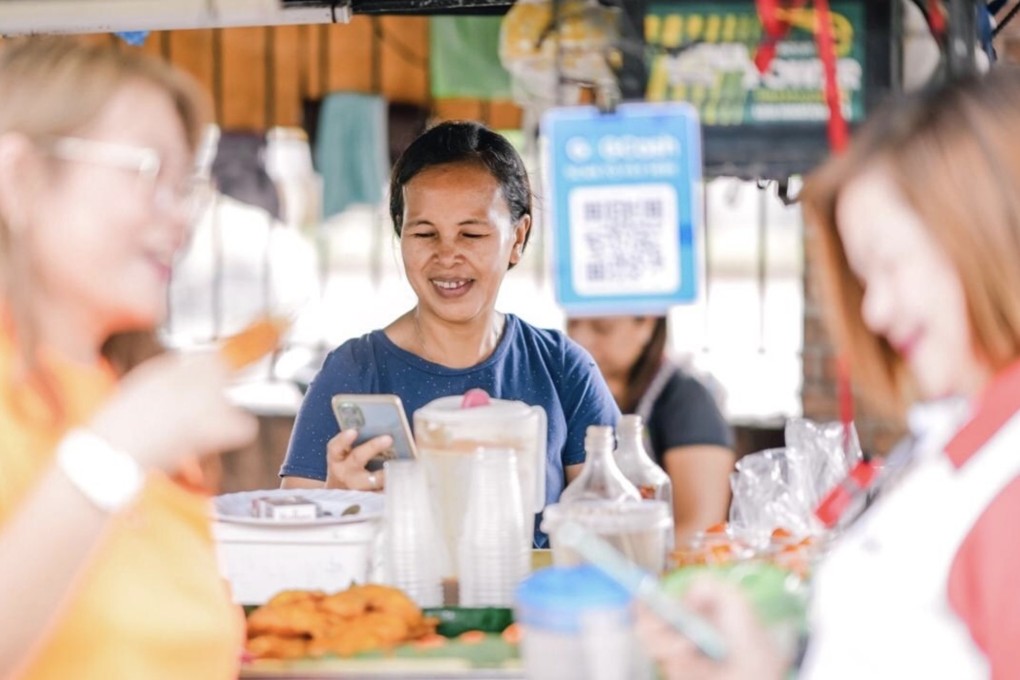 A woman using the GCash app in the Philippines. Photo: Handout