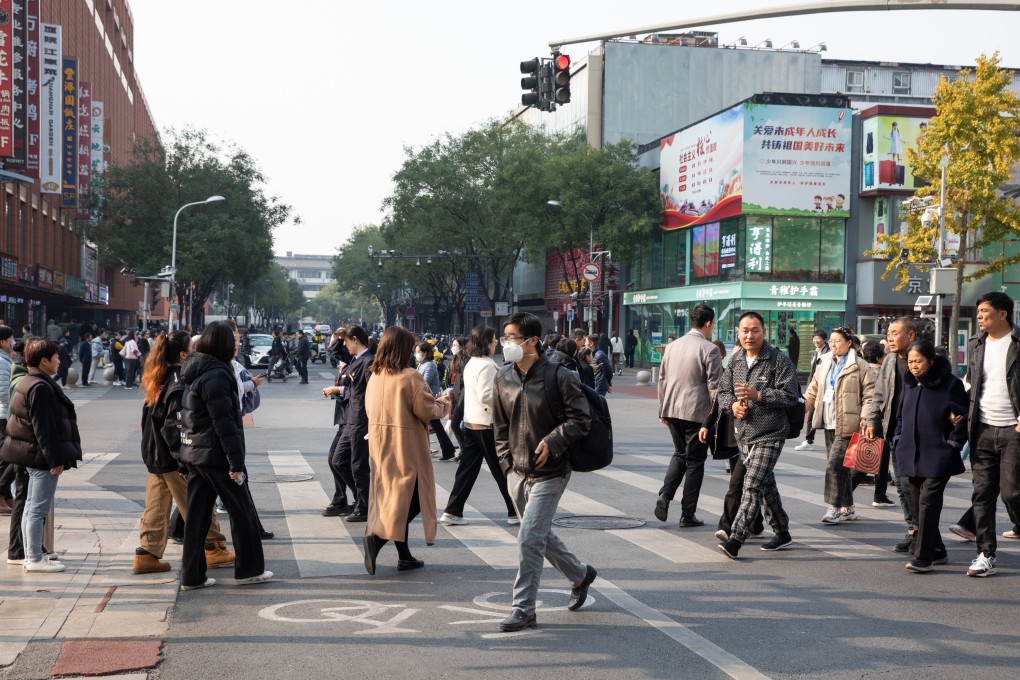 People walk on a shopping street in Beijing. Photo: EPA-EFE