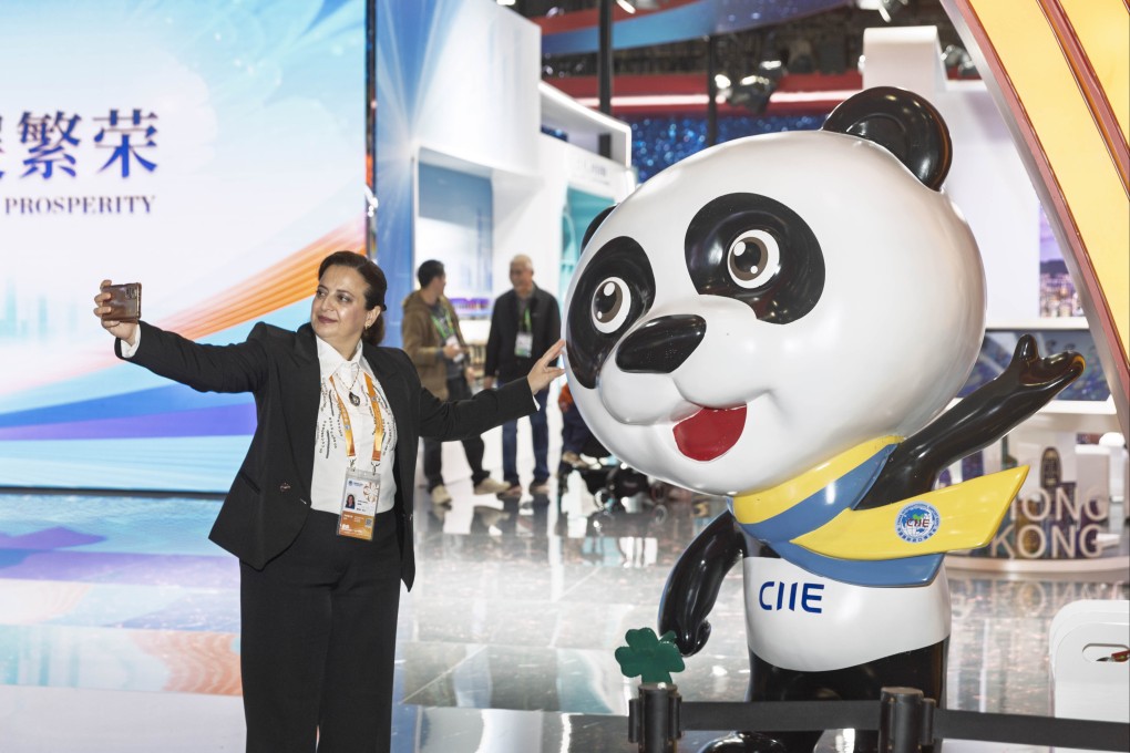 An exhibitor poses for a selfie with a panda mascot at the China International Import Expo in Shanghai this week. Photo: Xinhua