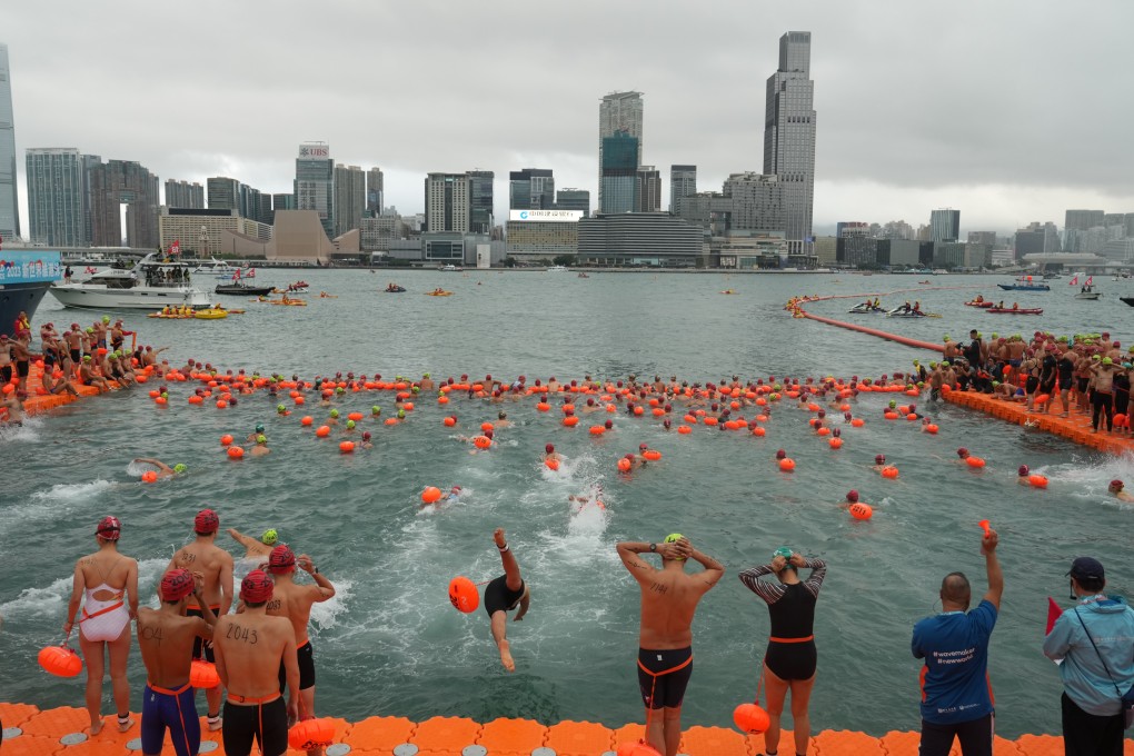 Swimmers take part in the New World Harbour Race last year. The annual race will be cancelled if the No 1 warning signal is in force on Sunday. Photo: Sam Tsang