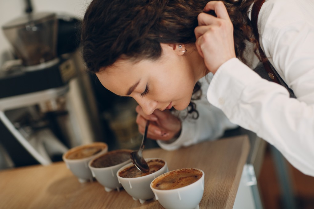 A woman laps up the aroma of coffee. Research is under way to develop new coffee varieties to benefit farmers and drinkers. Photo: Shutterstock
