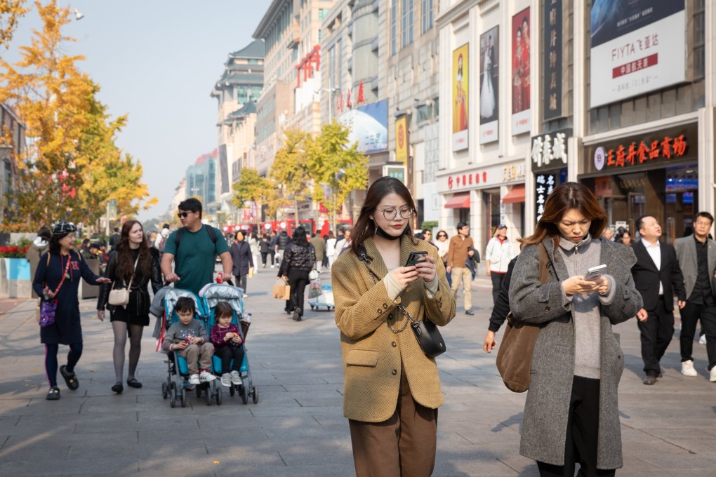 People walk down a shopping street in Beijing, China, on November 7. Photo:  EPA-EFE