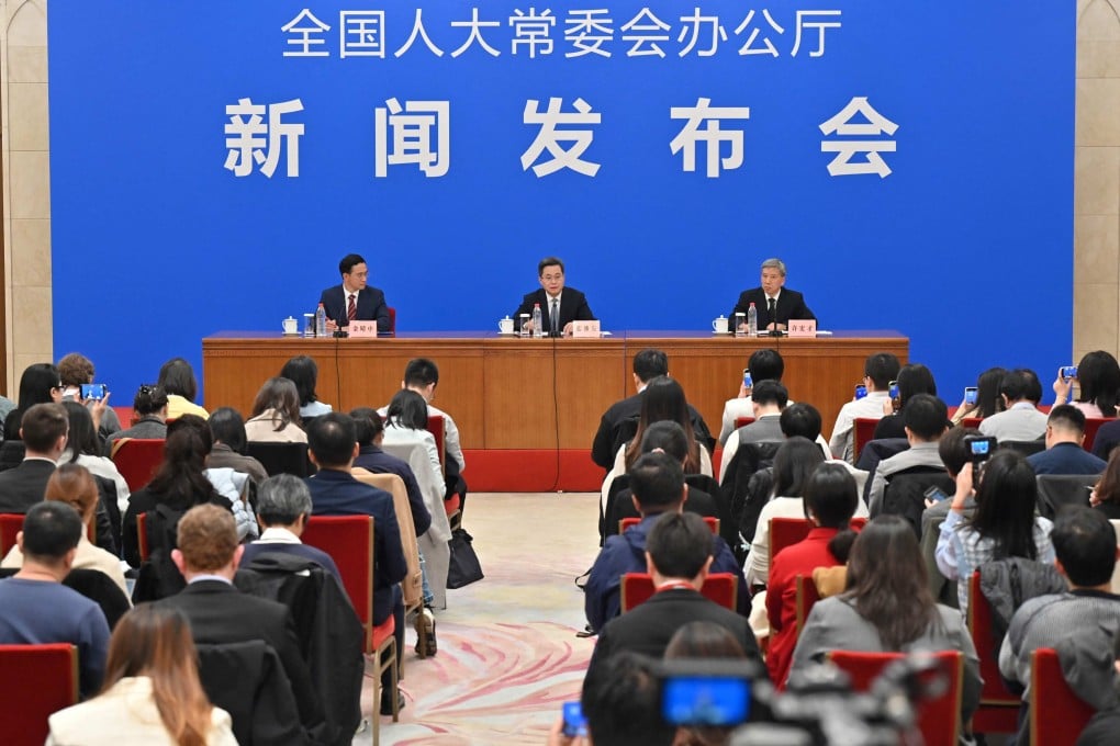 Chinese Minister of Finance Lan Foan (centre) speaks at a press conference in Beijing on Friday. Photo: AFP
