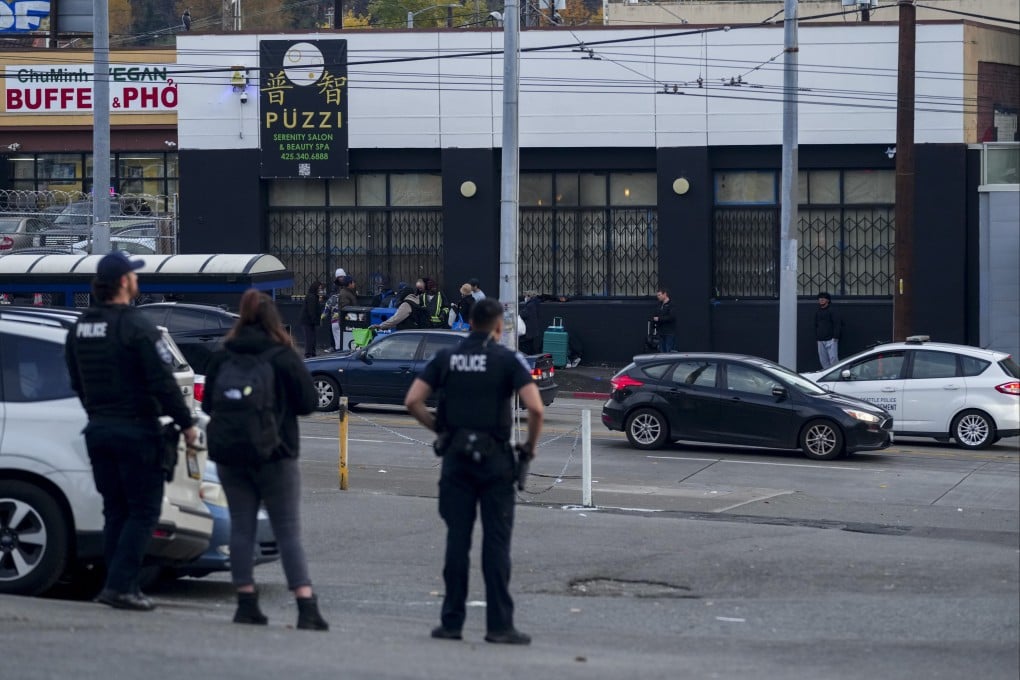 Police officers stand near the scene where multiple people were stabbed in Seattle’s Chinatown-International District on November 8. Photo: AP