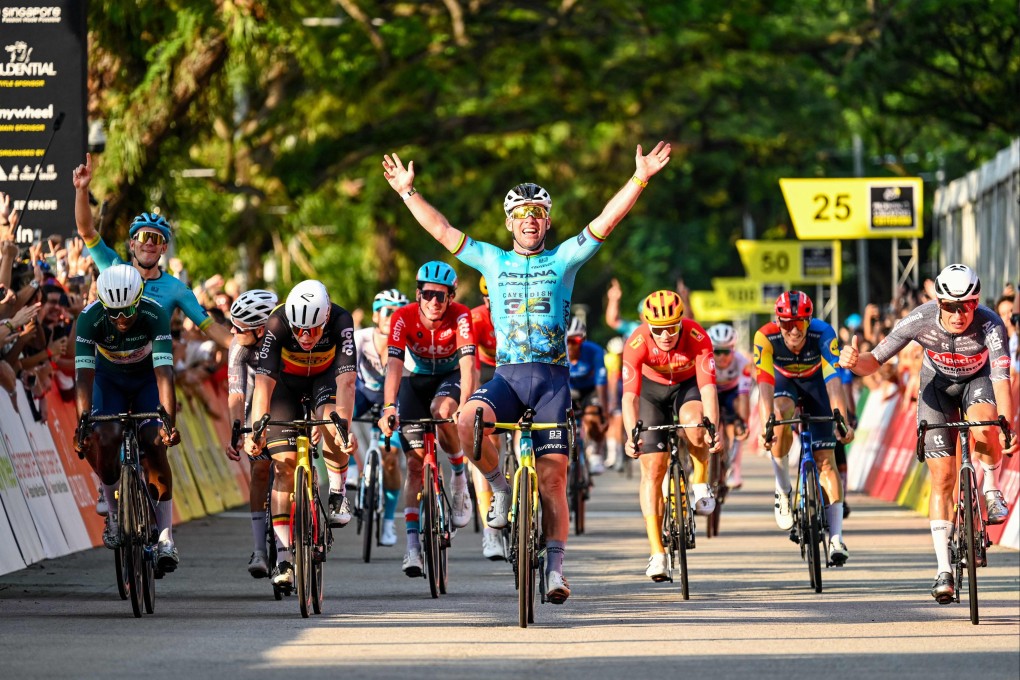 Britain’s Mark Cavendish (centre) celebrates as he crosses the finish line during the third Tour de France Singapore Criterium race on Sunday, to win the final race of his career. Photo: AFP