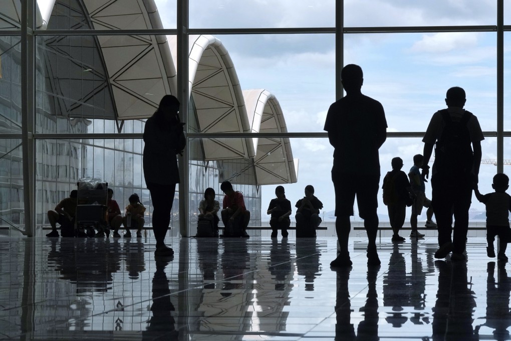 People wait at the Hong Kong International Airport. Photo: Elson Li