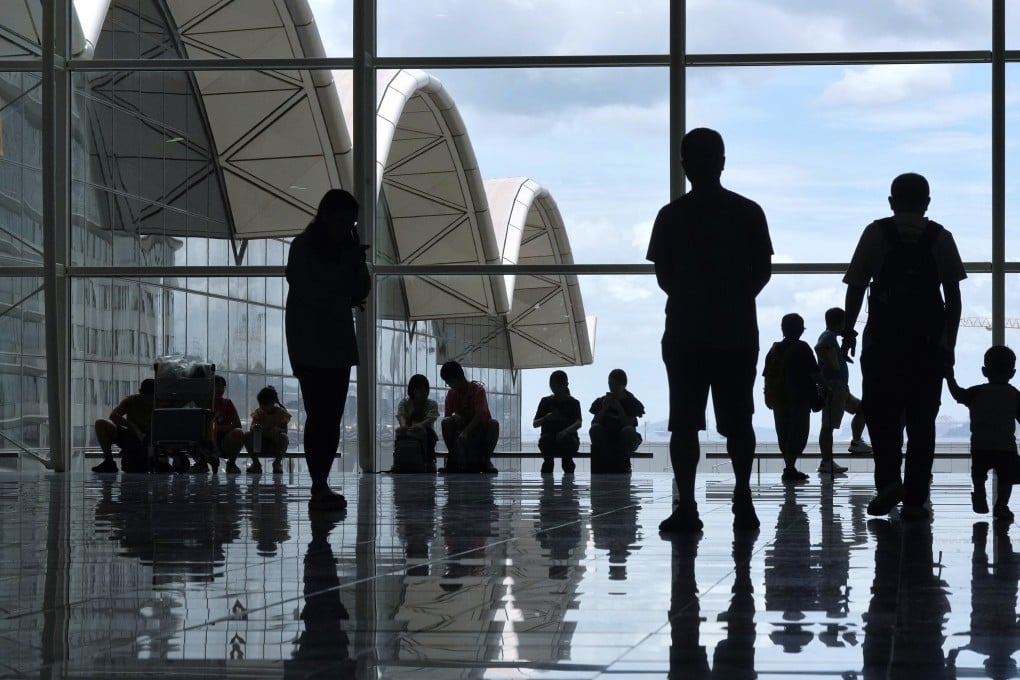 People wait at the Hong Kong International Airport. Photo: Elson Li