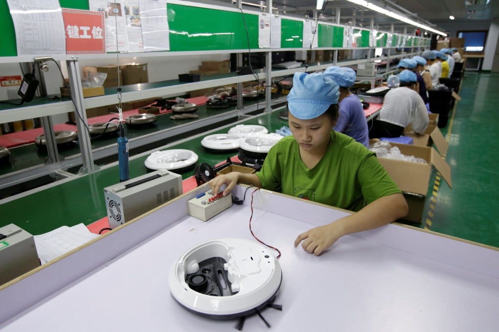An employee works on the production line of a robot vacuum cleaner factory in Shenzhen. Photo: Reuters