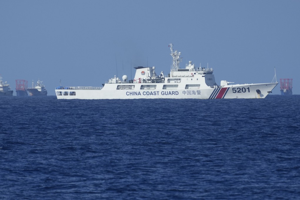A Chinese coastguard vessel pictured beside Chinese militia ships near Thitu Island in the South China Sea on Wednesday last week. Photo: AP