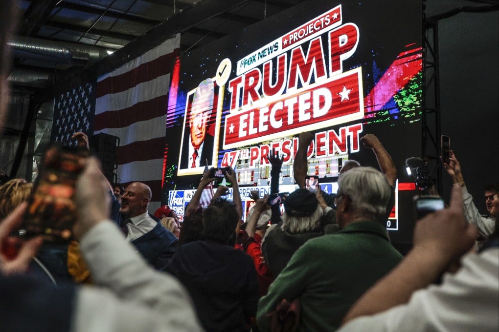 Supporters of Donald Trump celebrate after Fox News called the race for him at a Newtown watch party. Photo: TNS