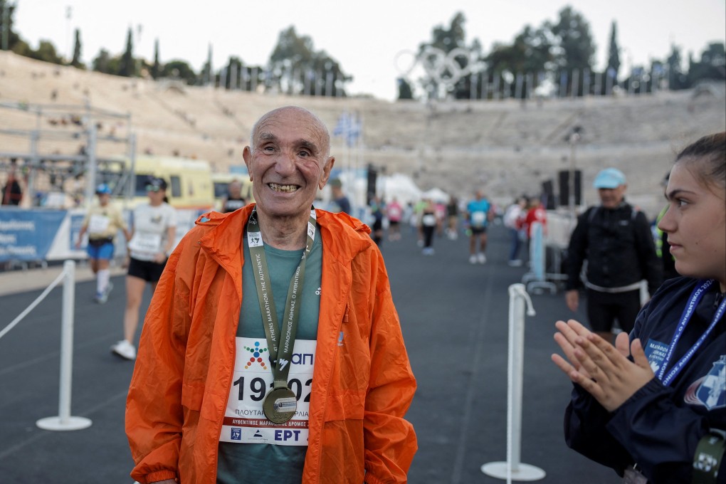 Ploutarchos Pourliakas, 88, the oldest runner in the 41st Athens Authentic Marathon, after receiving his medal at the Panathenaic Stadium in Athens on Sunday. Photo: Reuters
