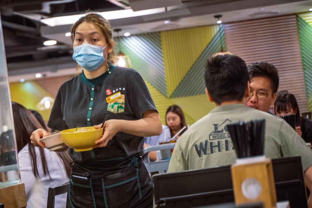 A female staff member carrying out a bowl of soup noodles at a Tam Jai restaurant in Causeway Bay, Hong Kong. Photo: Alexander Mak
