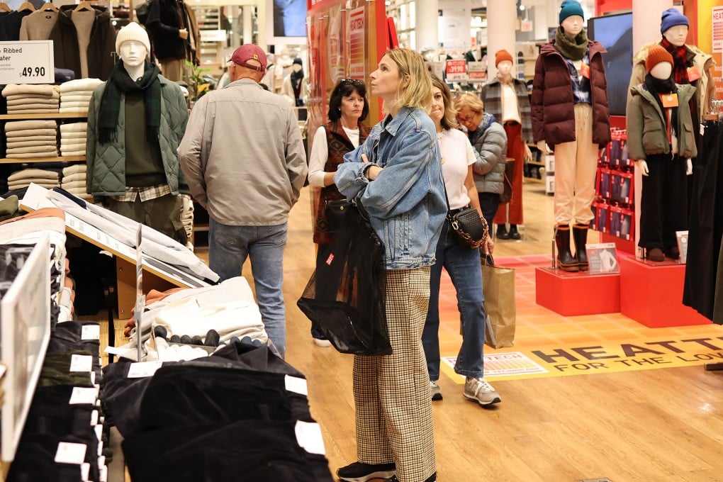 People shop at a Uniqlo store in New York on October 30. The Japanese operator of the clothing chain outsources production to countries including China, Vietnam, Bangladesh, Indonesia and India. Photo: TNS