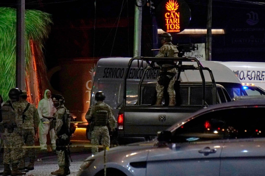 Mexican soldiers outside the Los Cantaritos bar where an armed group broke in on Sunday, killing 10 people. Photo: AFP