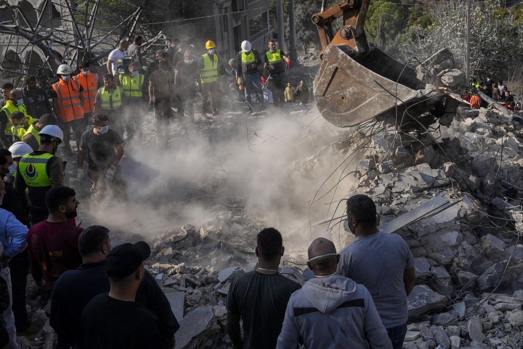 Rescuers search for victims under the rubble of a destroyed house hit in an Israeli strike in Aalmat village, northern Lebanon on Sunday. Photo: AP