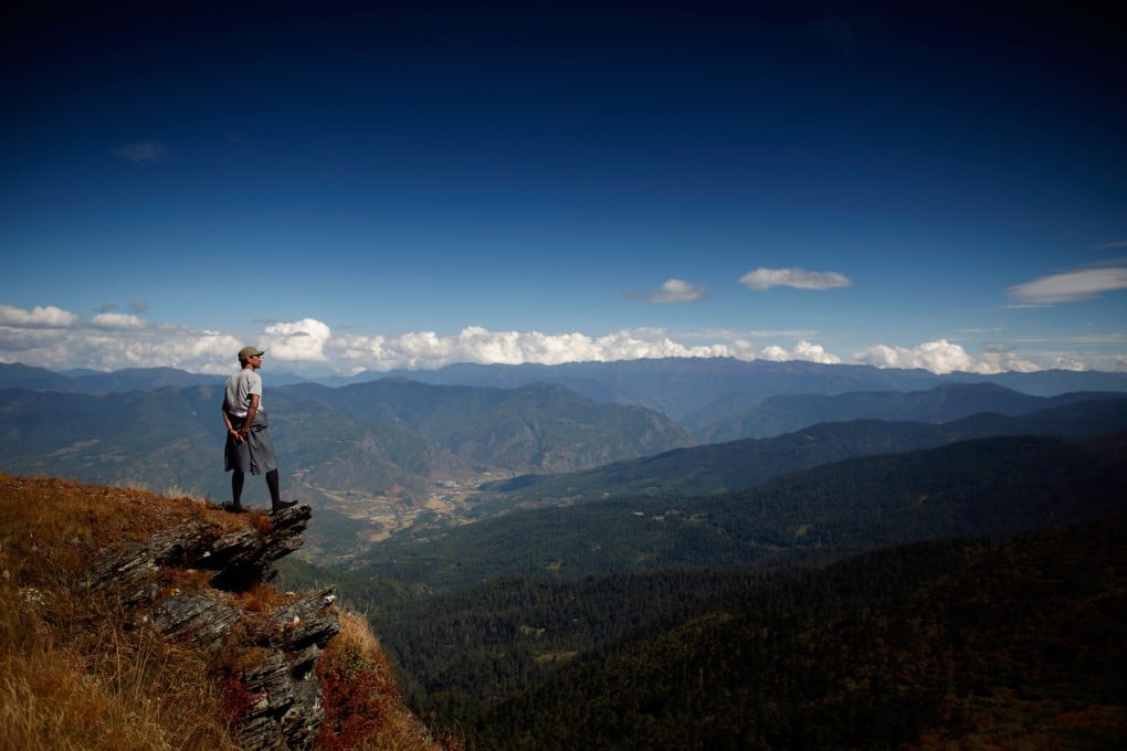 A Bhutanese man looks out over mountains in the South Asian nation. Photo: AFP