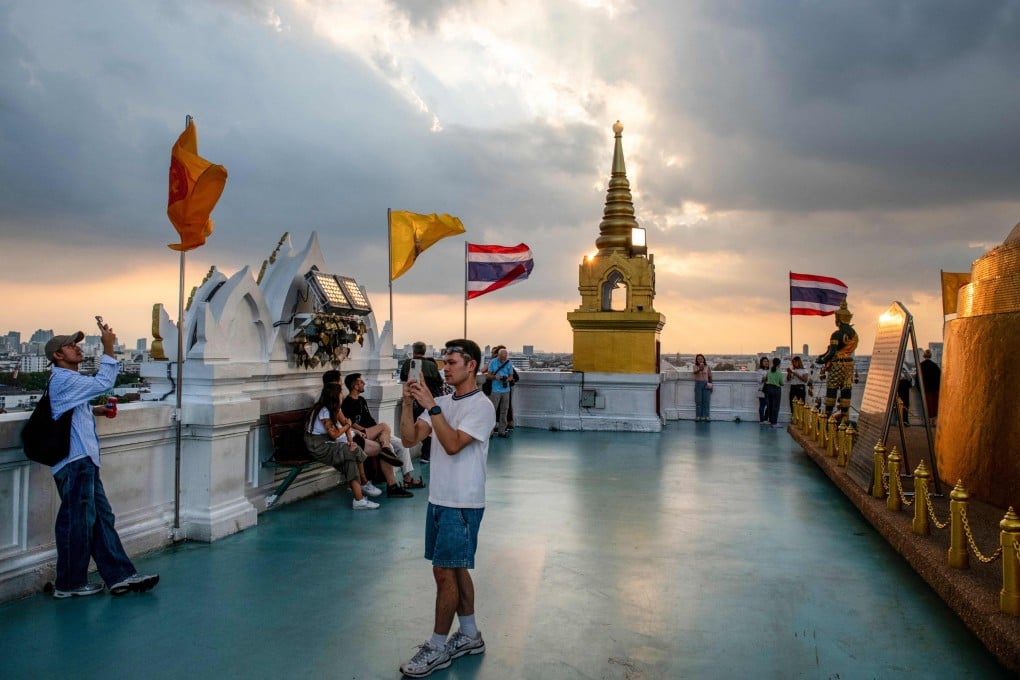 People visit the Golden Mount Temple at Wat Saket, an Ayutthaya-era Buddhist shrine, during sunset in Bangkok. Photo: AFP