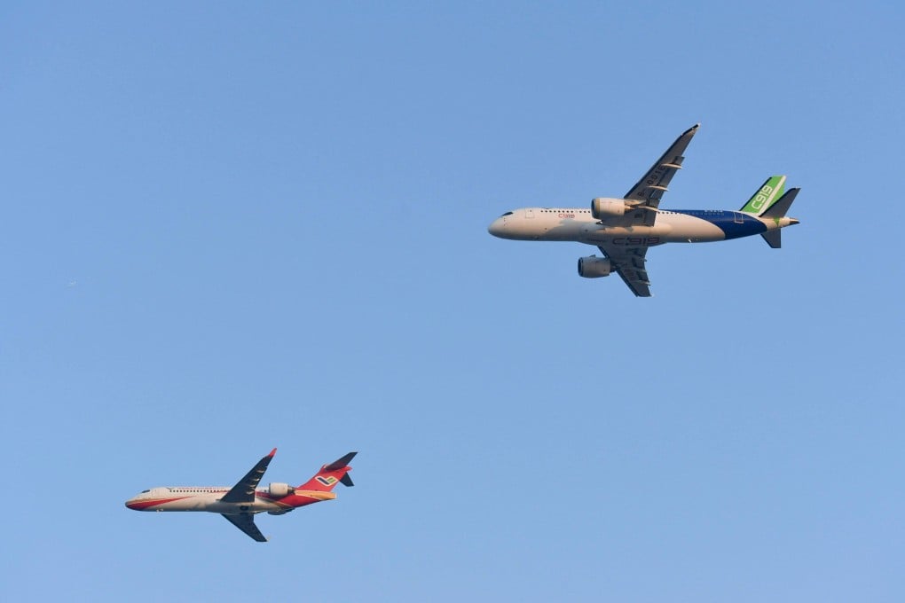 China’s domestically produced passenger jets, the C919 (right) and newly rebranded C909 (formerly the ARJ21), fly together at an air show in Jiangxi province on November 2. Photo: AFP