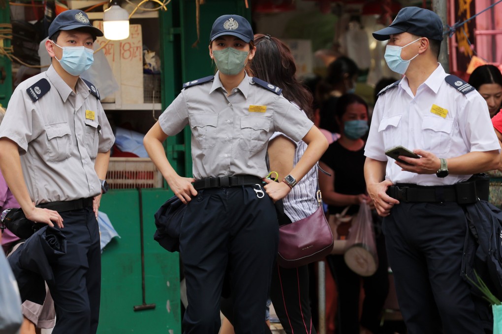 Officers from the Food and Environmental Hygiene Department patrol a street in Mong Kok. Photo: Jelly Tse