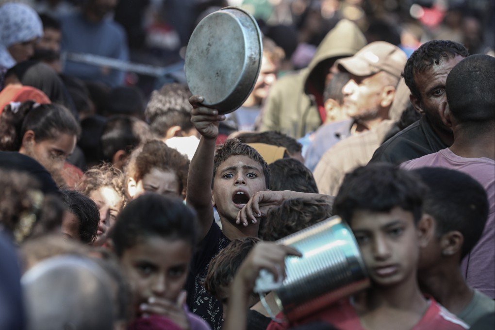 Palestinian children wait to receive food distributed by an aid organisation in Deir Al Balah, Gaza. Photo: APA Images via ZUMA Press Wire/dpa