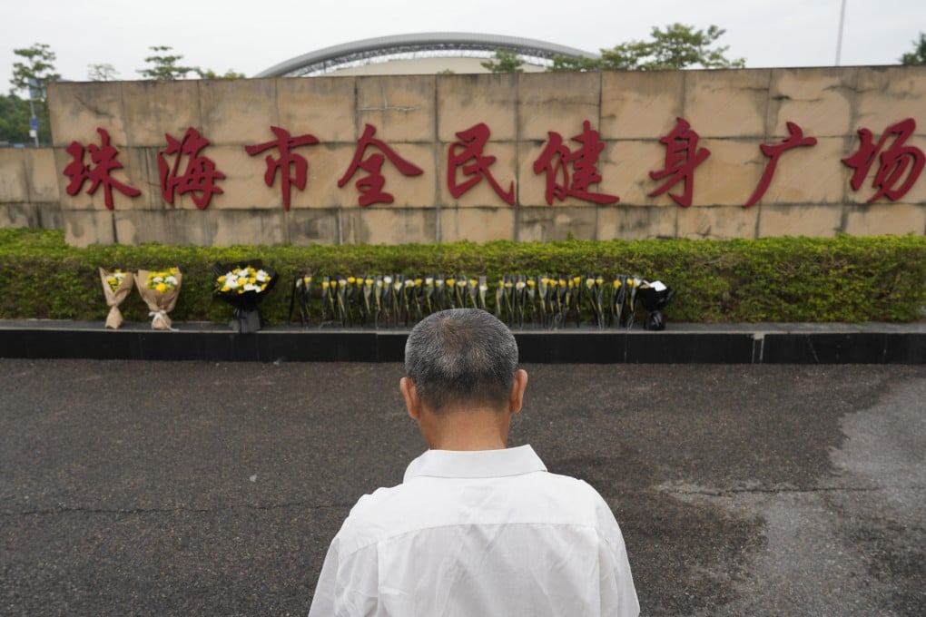 A local man looks at flowers laid outside the scene of the deadly attack in Zhuhai on Wednesday. Photo: AP