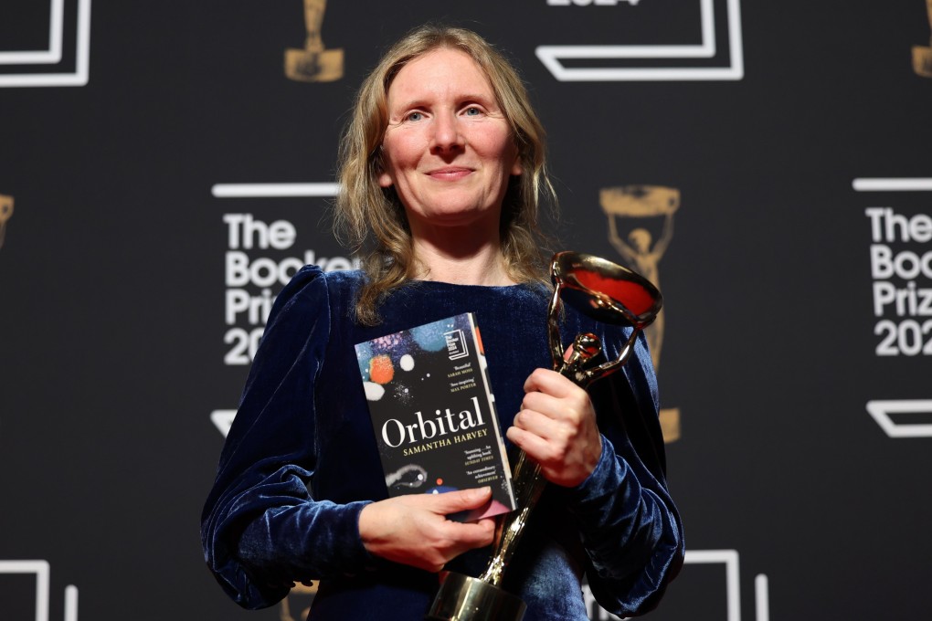 British novelist Samantha Harvey, author of the book “Orbital”, holds her trophy and a copy of her novel after winning the 2024 Booker Prize in London on Tuesday. Photo: EPA-EFE