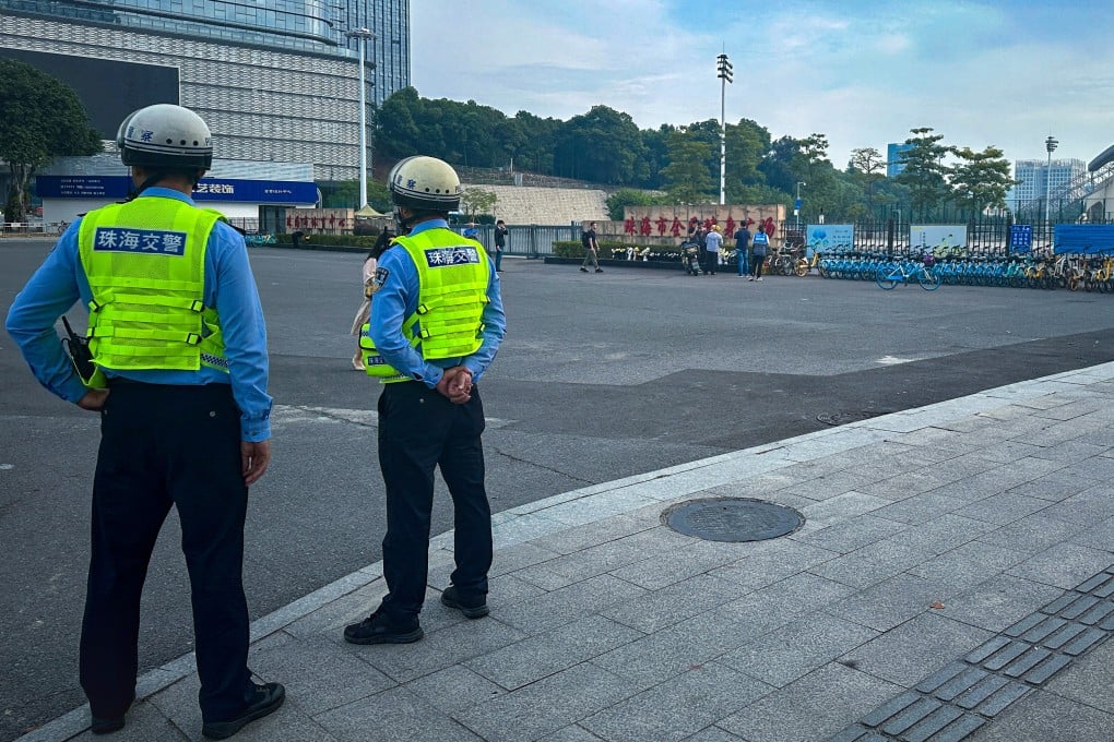 Police officers stand outside the stadium where a deadly car attack took place in Zhuhai, Guangdong province. Photo: Reuters