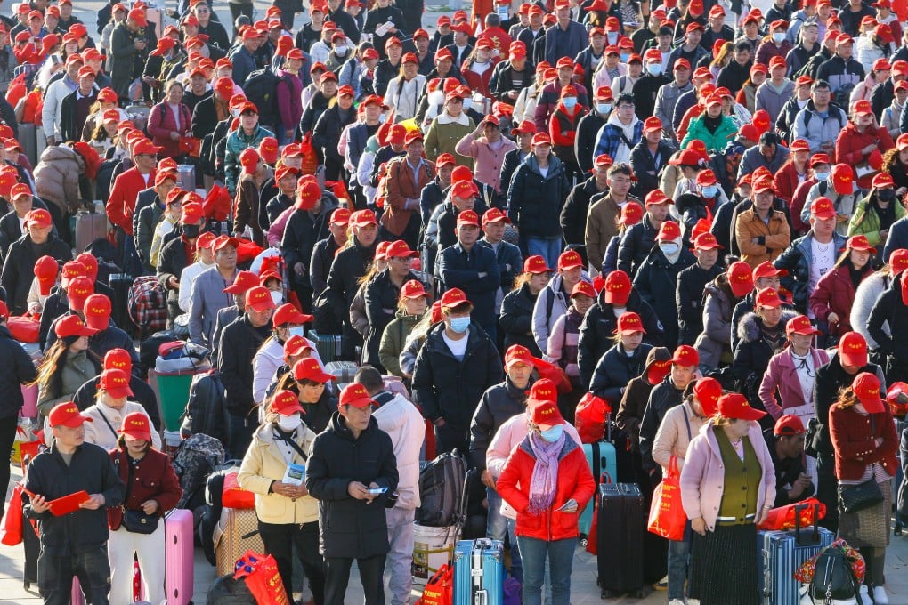 Migrant workers attend a farewell ceremony at a railway station in Qujing, Yunnan province, in February. Photo: VCG via Getty Images