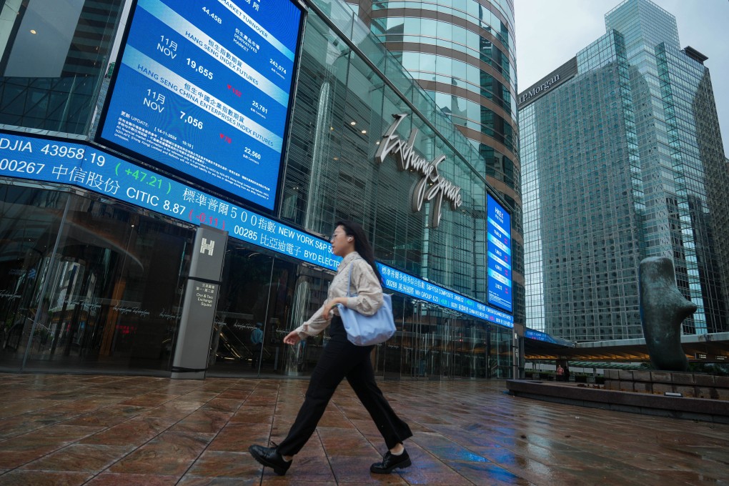 Pedestrians walk past Exchange Sqaure in Central under the Storm Signal No.8. Photo: Sam Tsang
