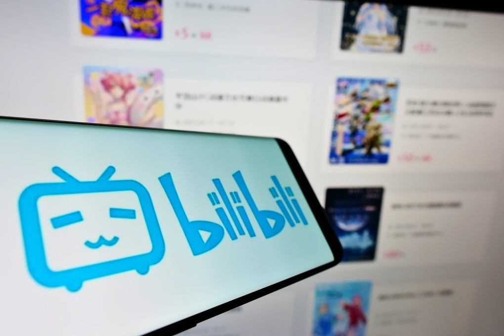 The Bilibili logo is displayed on a smartphone screen in front of the company’s website. Photo: Shutterstock Images