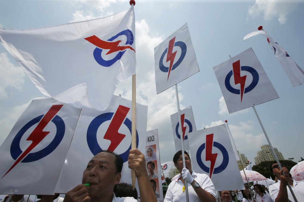 Supporters of Singapore’s ruling People’s Action Party (PAP) wave party flags and placards ahead of the general election in 2015. Photo: Reuters