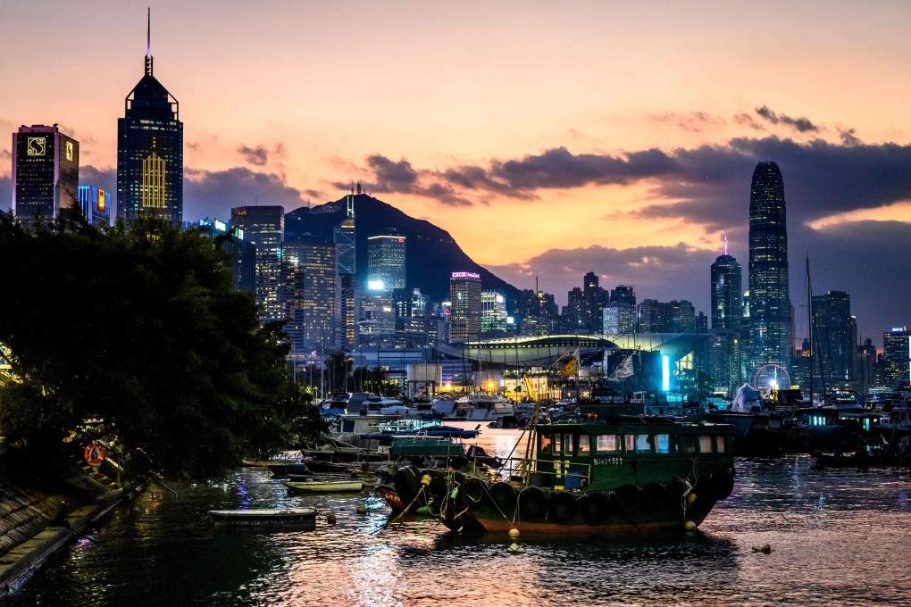 The sun sets behind Hong Kong’s skyline on November 1. Photo: AFP