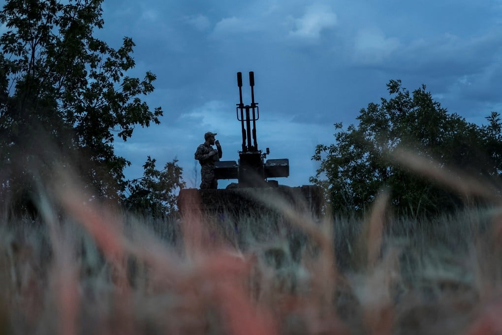 A Ukrainian serviceman stands next to an anti-aircraft cannon as he watches out for Russian kamikaze drones, in Kherson region earlier this year. Photo: Reuters