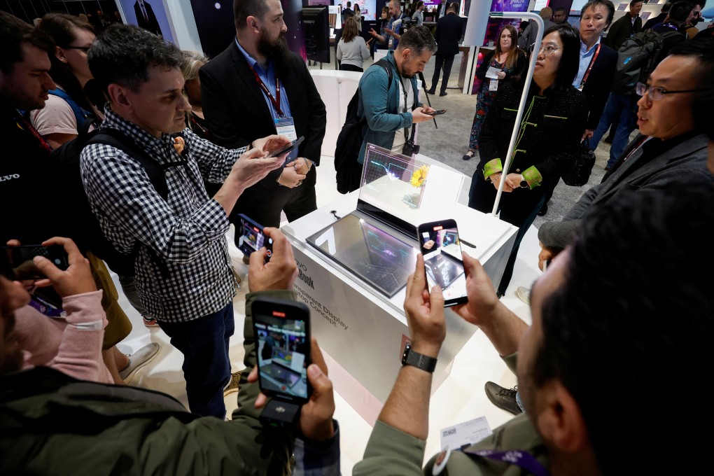 Visitors take photos of the Lenovo’s ThinkBook concept laptop with a transparent display at the 2024 Mobile World Congress (MWC) in Barcelona, Spain, on February 26. Photo: Reuters