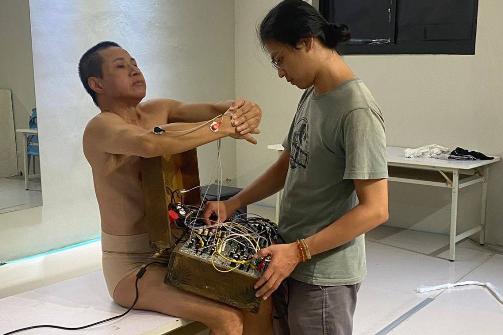 Daniel Yeung (left) is wired up for a rehearsal of Freespace Dance-exhibitionist, a nude dance work he will perform in Hong Kong’s West Kowloon Cultural District. Photo: Hoi Chiu
