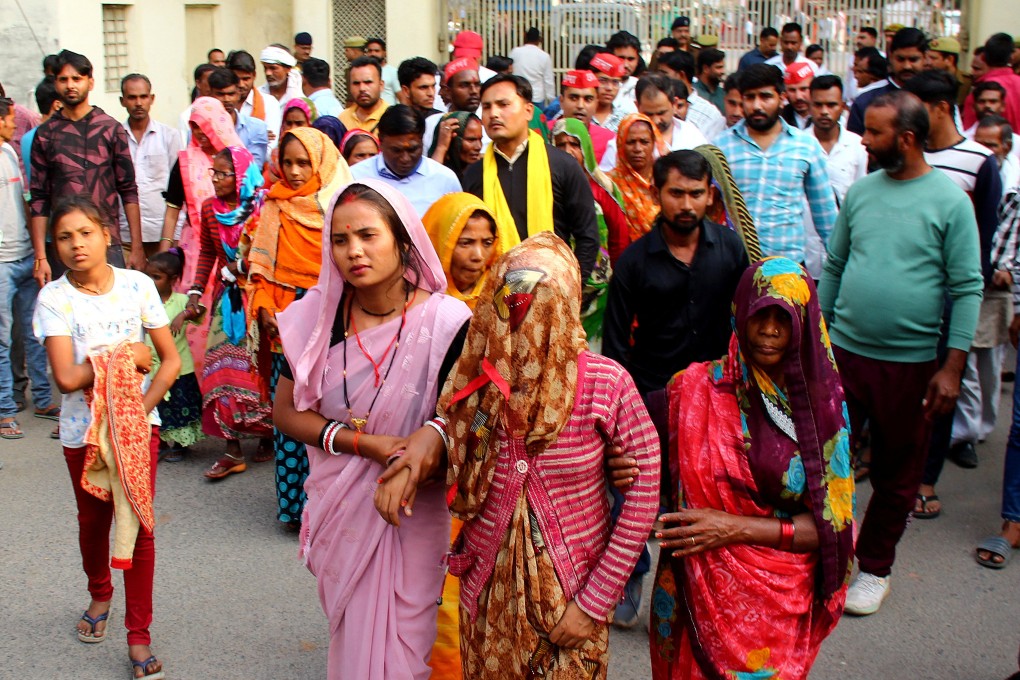 A mother of a newborn leaves with her relatives after she identified her son, who is being treated in a private hospital after he was rescued from the fire, on Saturday. Photo: Reuters