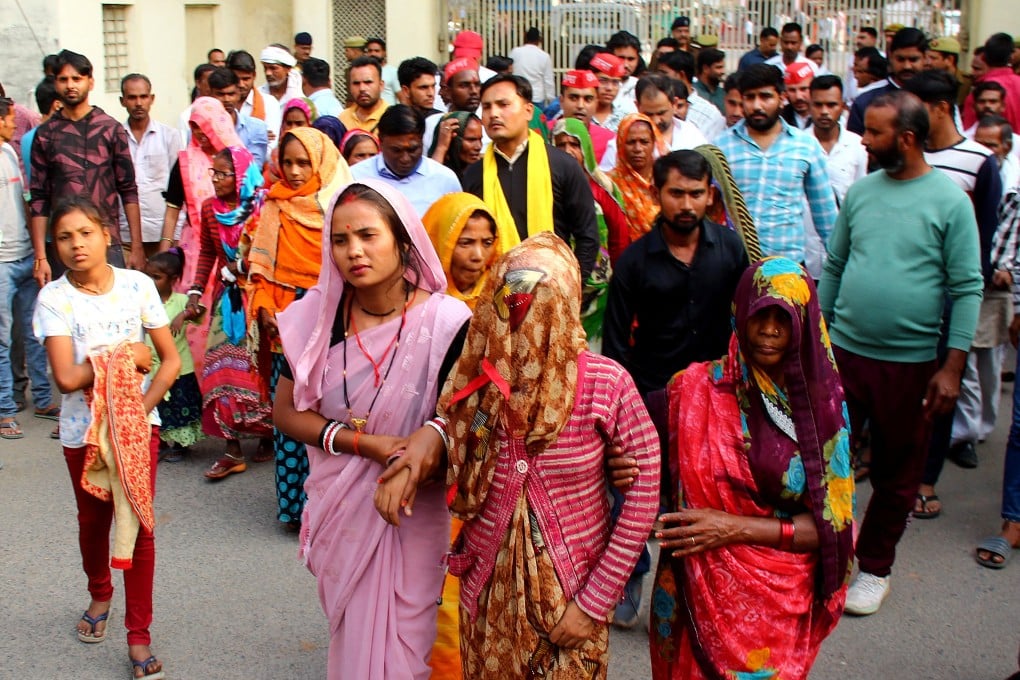 A mother of a newborn leaves with her relatives after she identified her son, who is being treated in a private hospital after he was rescued from the fire, on Saturday. Photo: Reuters