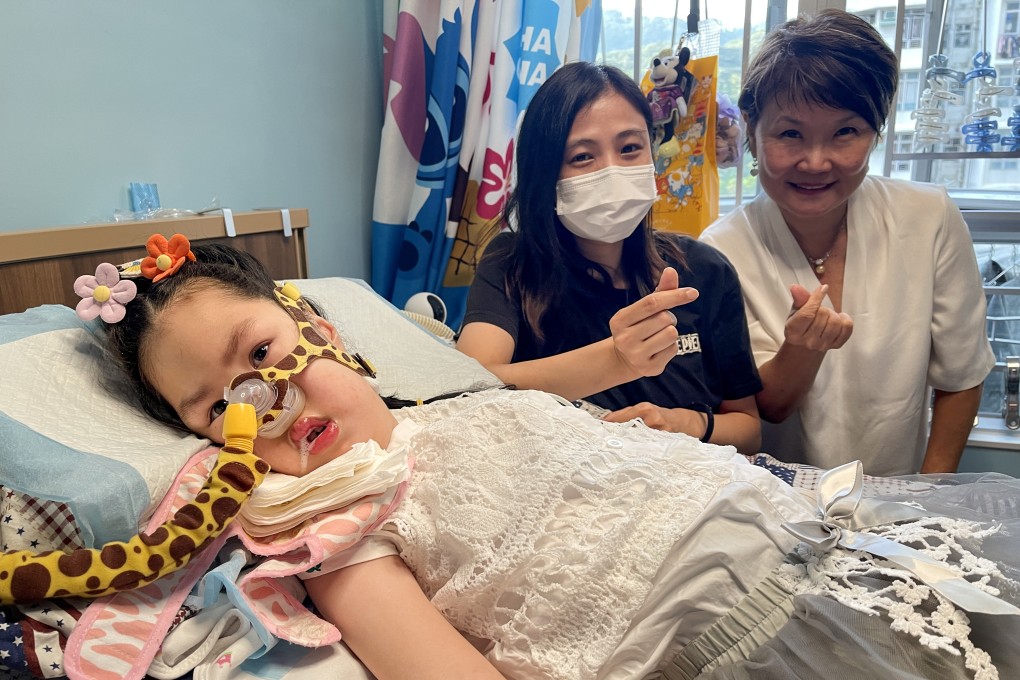 Cheuk Ka, a child with spinal muscular atrophy, is joined by her mother (centre) and Families of SMA Foundation founder Fok Mei-ling. Photo: Cindy Sui