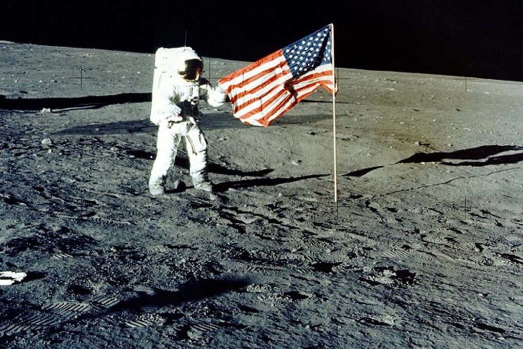 Charles “Pete” Conrad Jr stands with the US flag on the lunar surface during the Apollo 12 mission, in 1969. Photo: Nasa/Handout