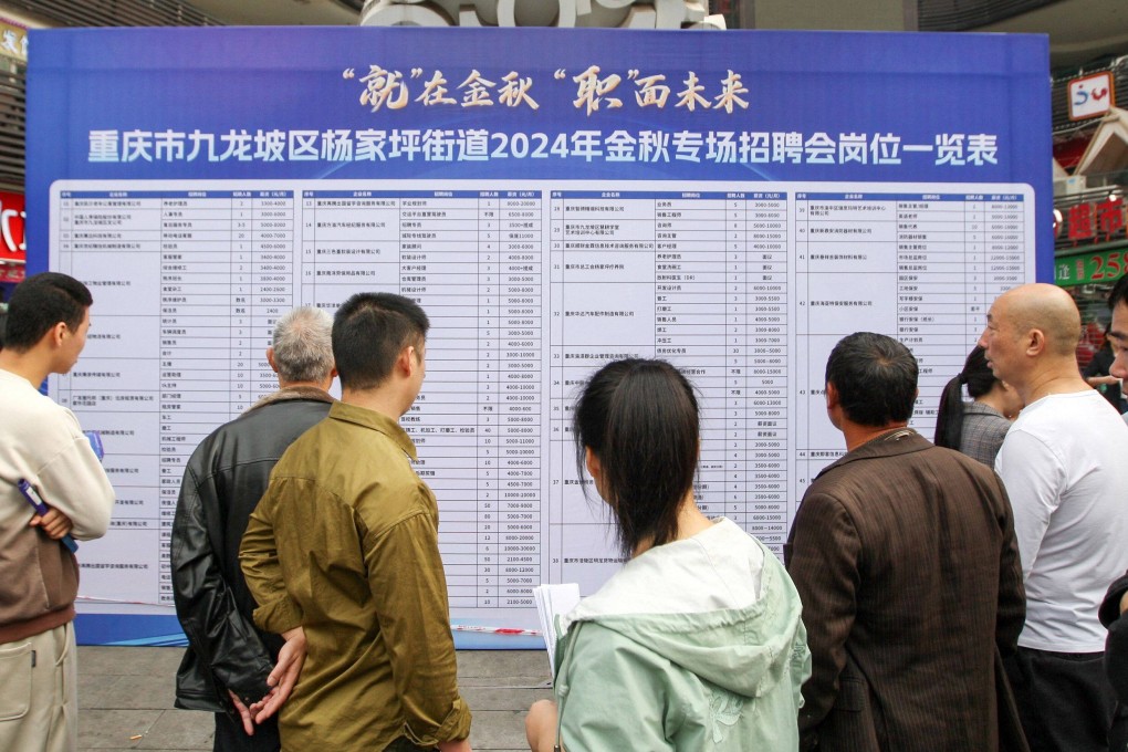 People look at job listings at a job fair in Chongqing, in southwest China on November 7, 2024. (Photo by AFP) / China OUT